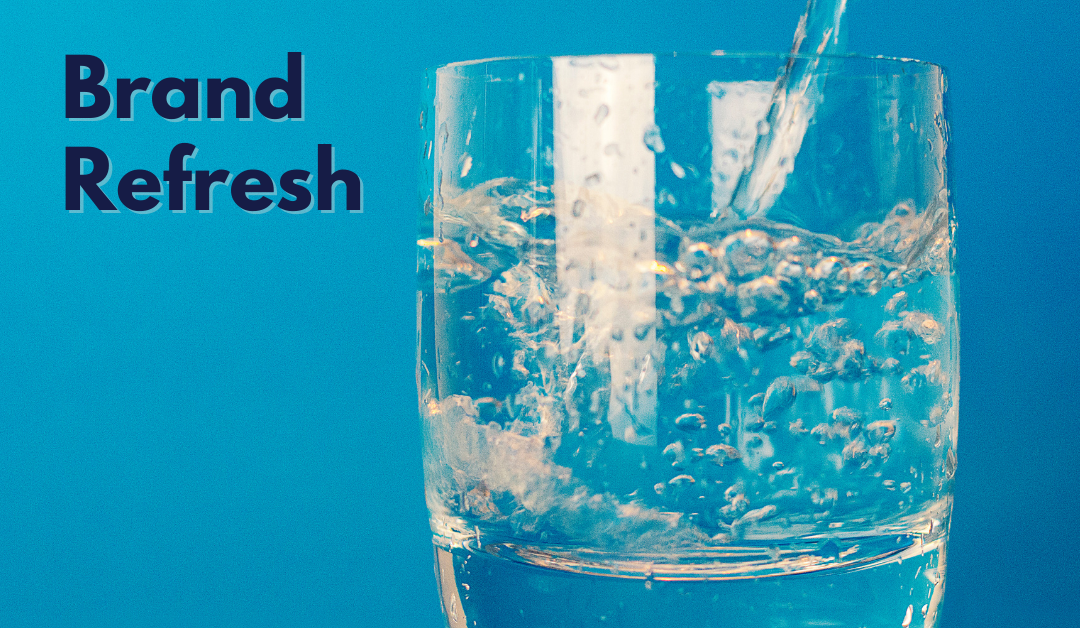 Blue ombre background with a glass being filled with water and the words, "brand refresh" at the top left corner of the image.