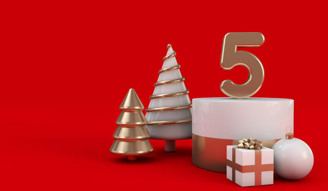 Image with red background, silver and gold Christmas tree figurines, white Christmas ornament, white and red gift box, and number 5 figurine on top of a white candle.