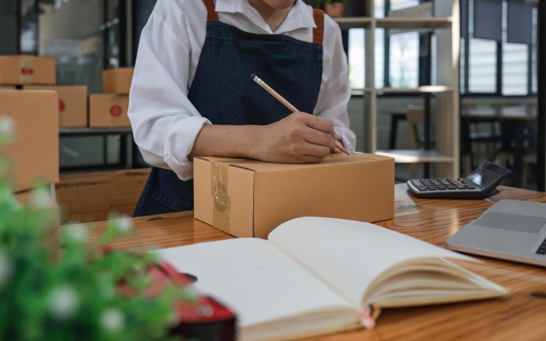 Business owner writing on a parcel for their business