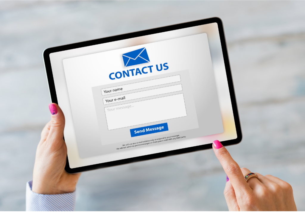 an image of a person holding a tablet that has a "contact us" form on the screen - one tip for a digital refresh 