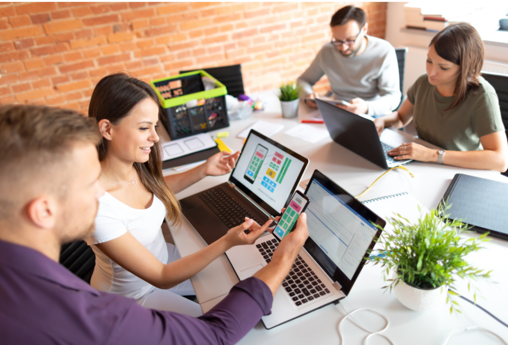 an image of a group of people planning on their laptops - one of the 6 ways we make your business look good